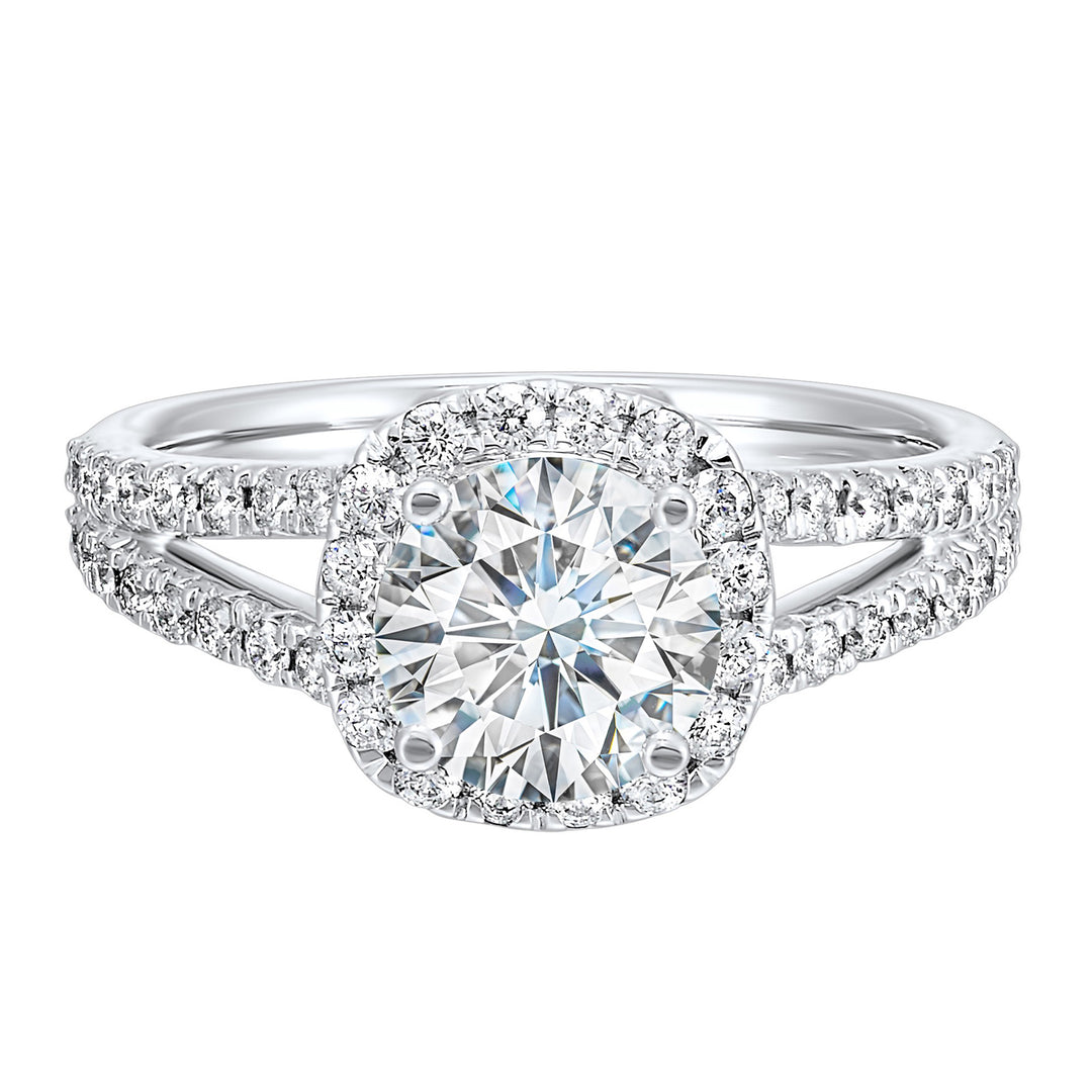 Cushion halo is a stunning way to showcase the round solitaire diamond. Modern split diamond studded shank further highlights the center.