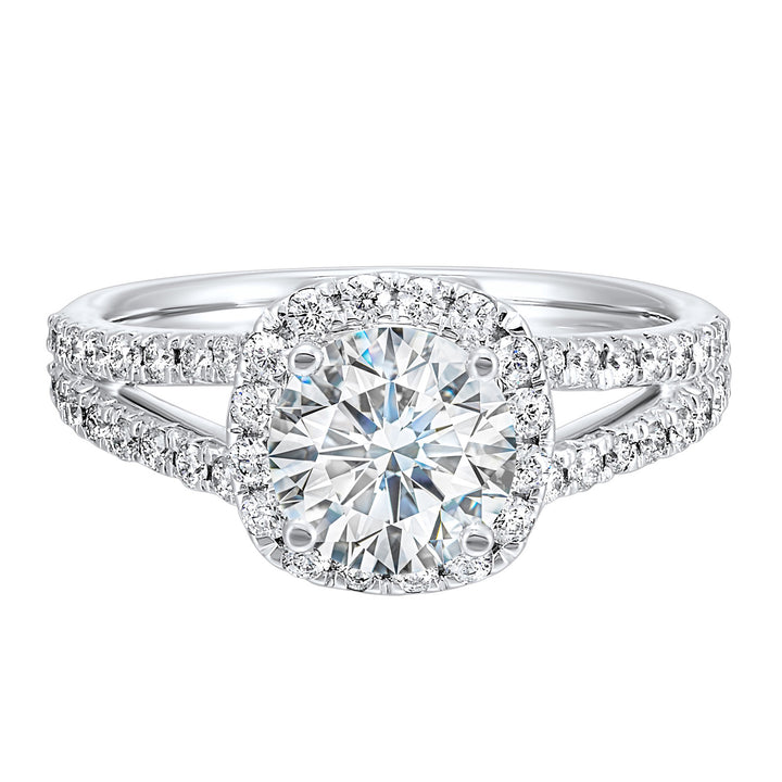 Cushion halo is a stunning way to showcase the round solitaire diamond. Modern split diamond studded shank further highlights the center.