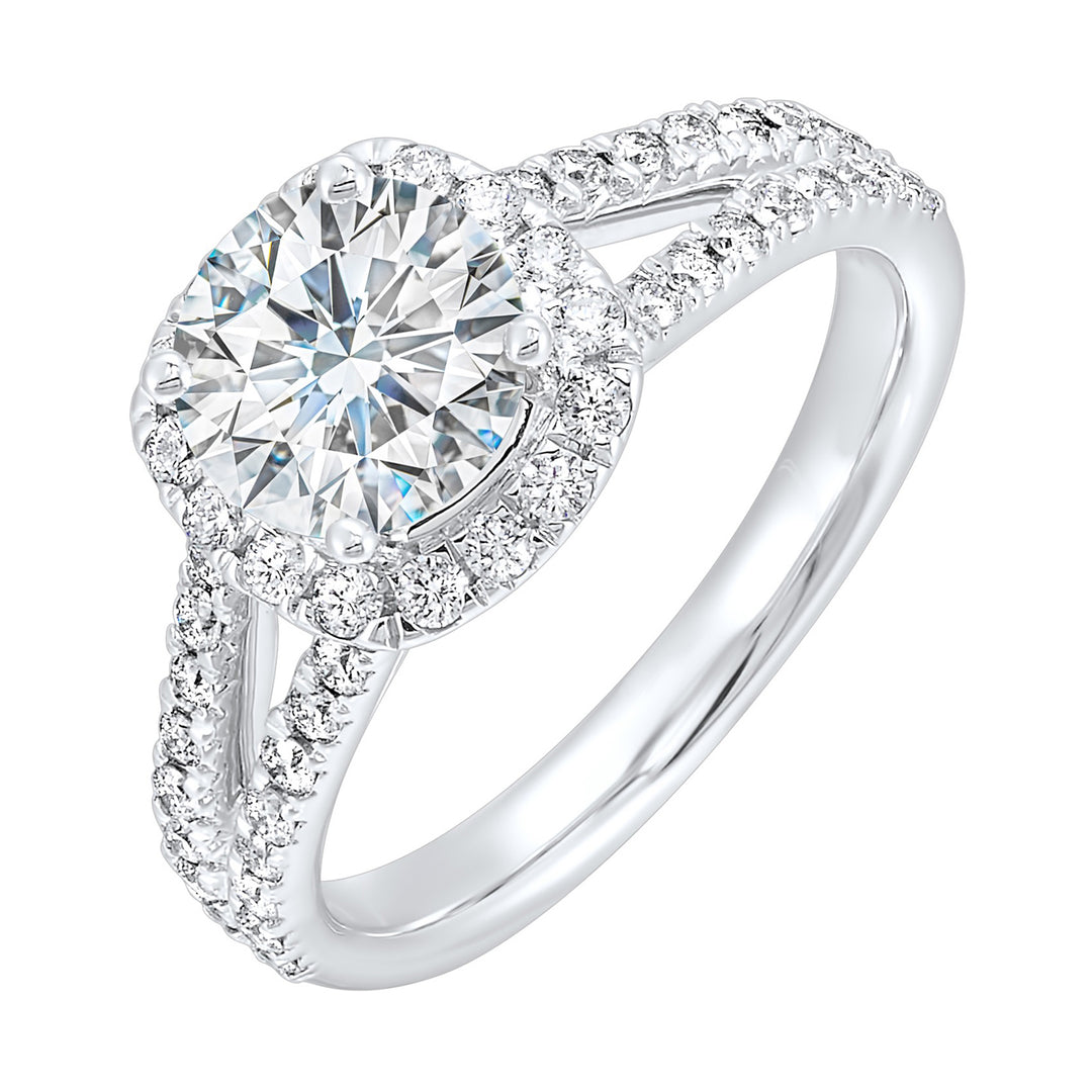 Cushion halo is a stunning way to showcase the round solitaire diamond. Modern split diamond studded shank further highlights the center.