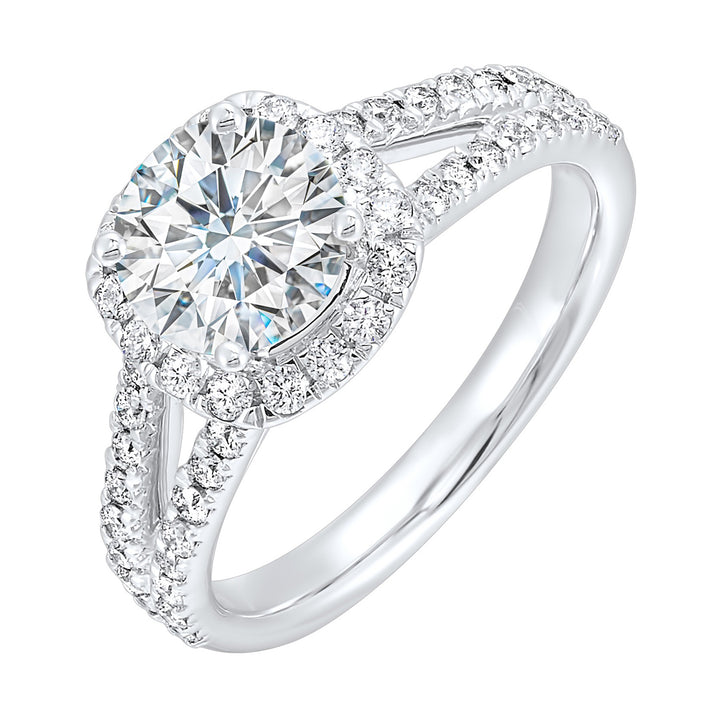 Cushion halo is a stunning way to showcase the round solitaire diamond. Modern split diamond studded shank further highlights the center.