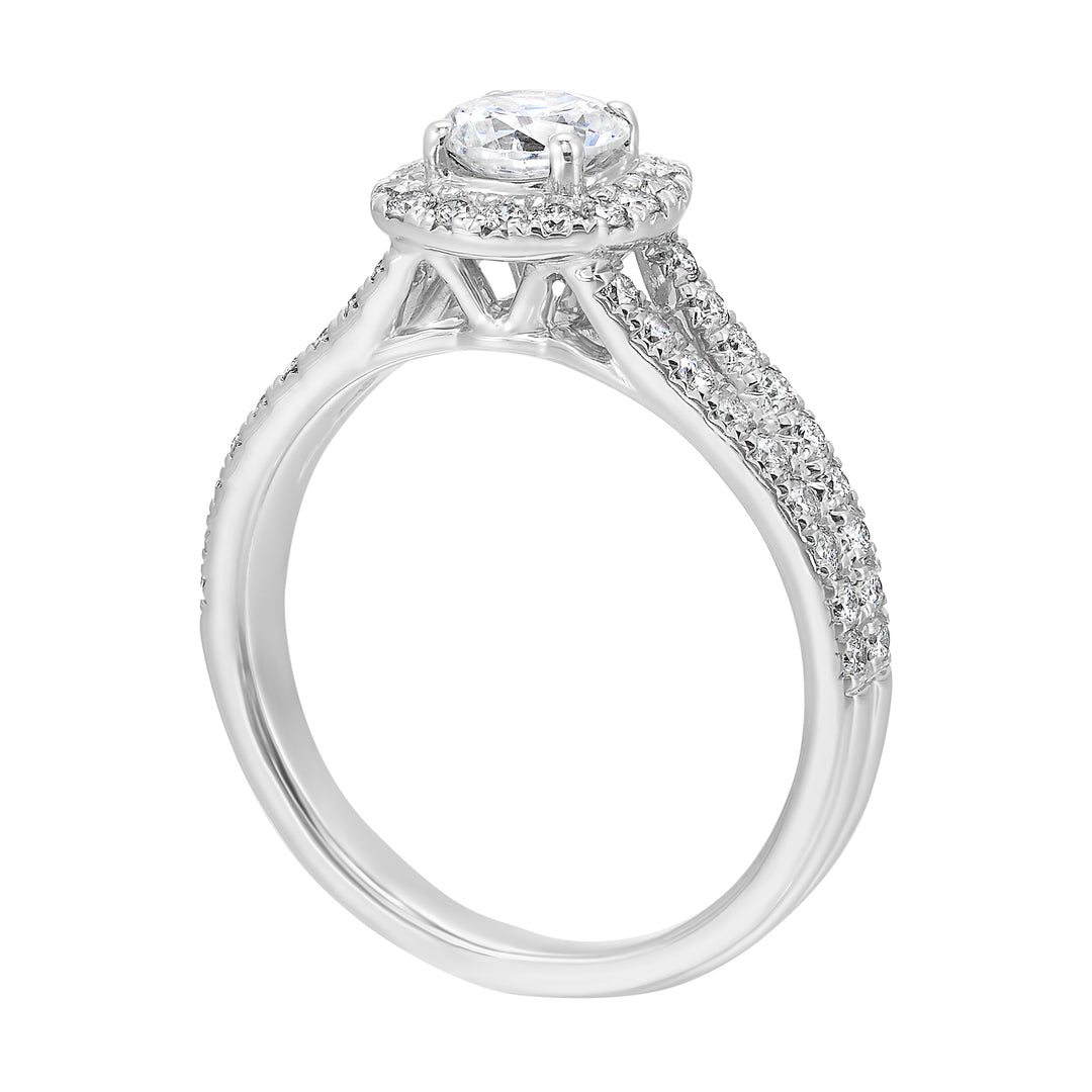 Cushion halo is a stunning way to showcase the round solitaire diamond. Modern split diamond studded shank further highlights the center.