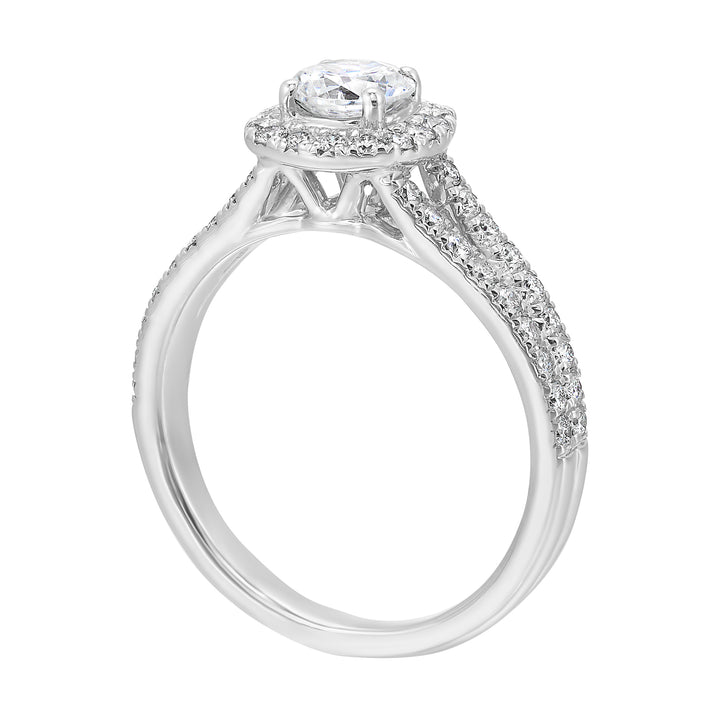 Cushion halo is a stunning way to showcase the round solitaire diamond. Modern split diamond studded shank further highlights the center.