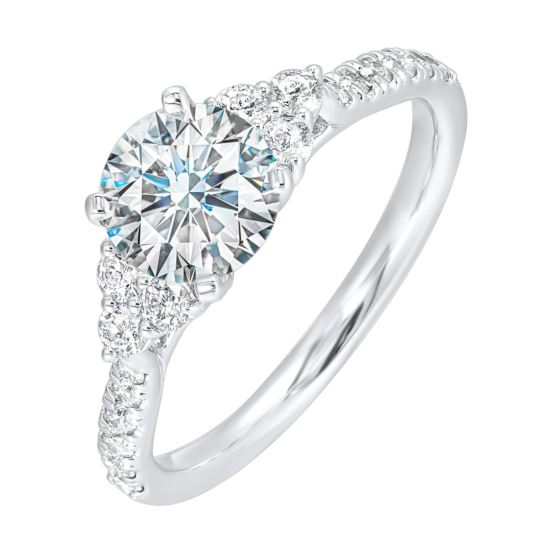 A trio of round diamonds on either side of the solitaire followed by a diamond studded shank, this ring is sure to impress her.