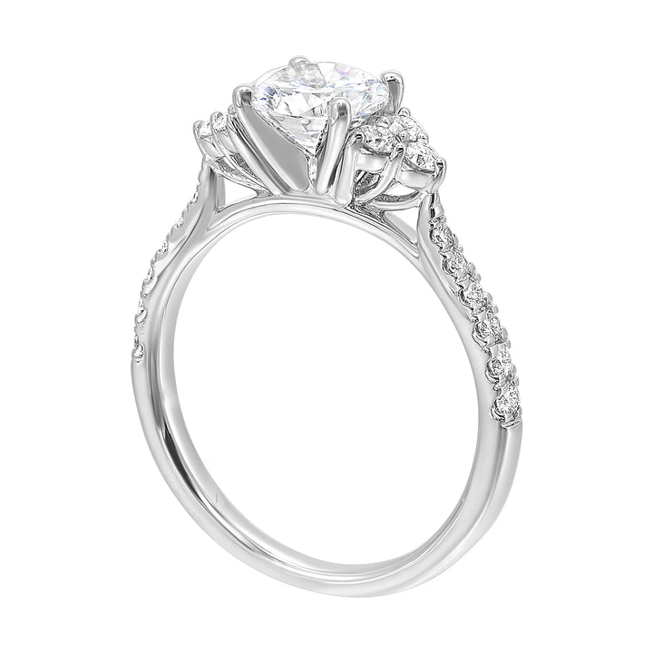 A trio of round diamonds on either side of the solitaire followed by a diamond studded shank, this ring is sure to impress her.