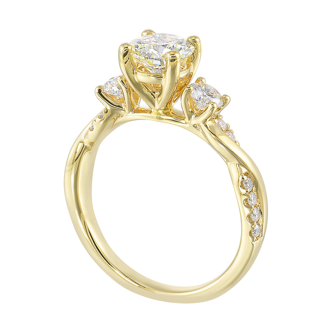 Gorgeous three stone ring features a round solitaire with one smaller diamond on either side. All of this sits a top a criss cross band with playful flow of diamond is a perfect choice.