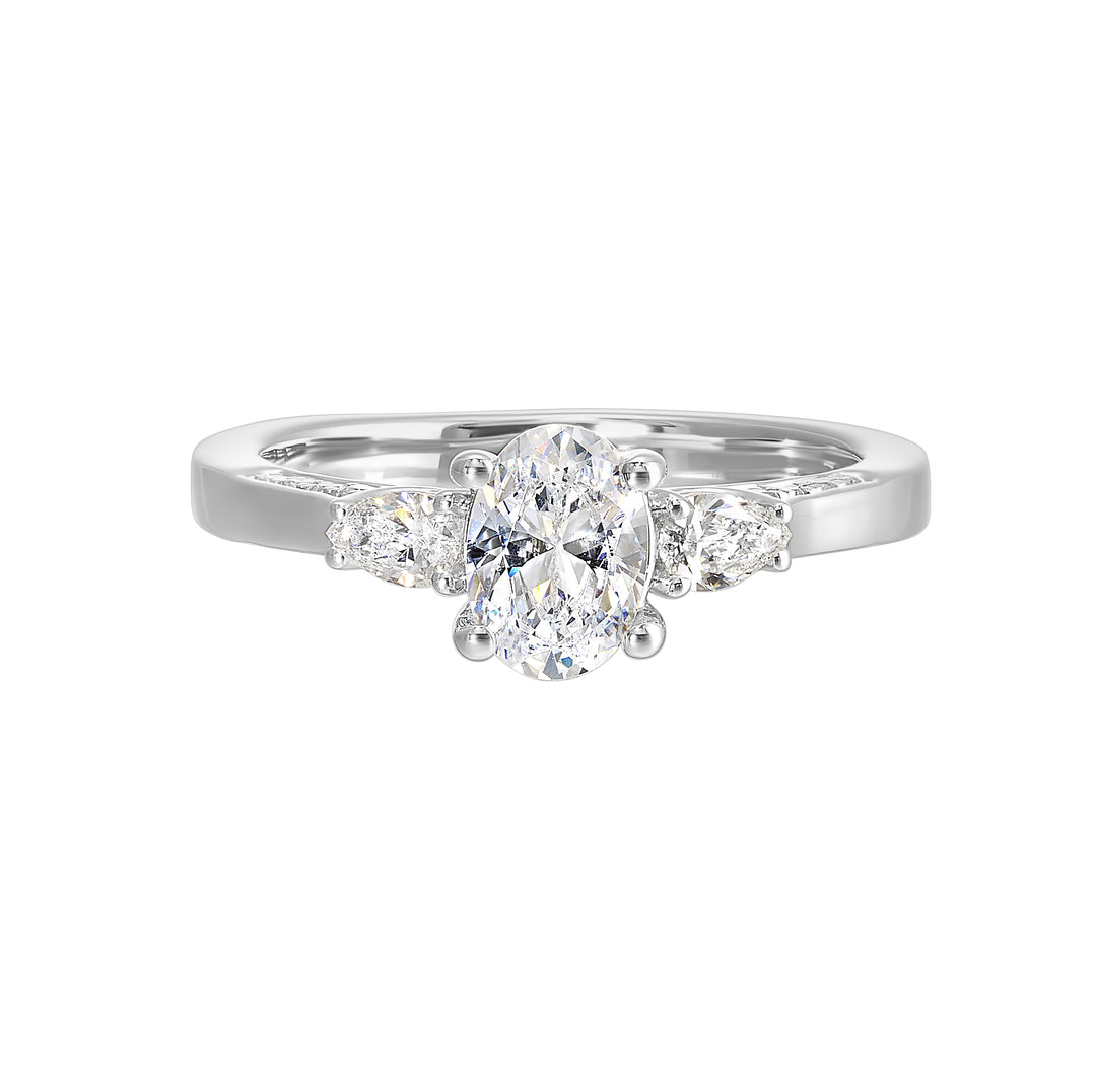 Three stone ring features an oval cut solitare nestled inbetween pear cut diamond, all embellished with sparkling diamond accents in front.