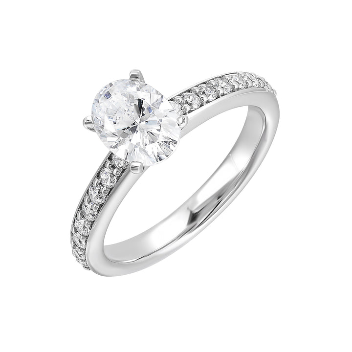 Sleek and beautiful, this diamond engagement ring set with pave diamonds complements the oval solitare.