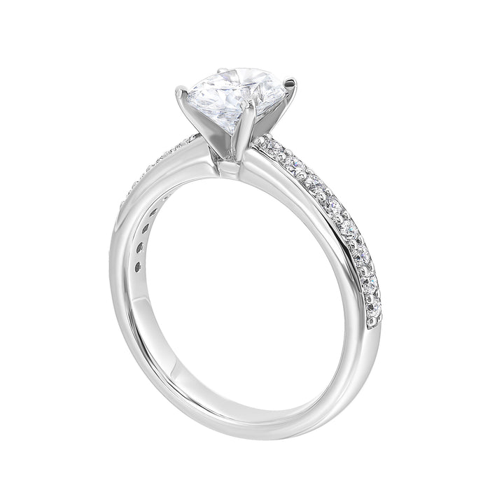 Sleek and beautiful, this diamond engagement ring set with pave diamonds complements the oval solitare.