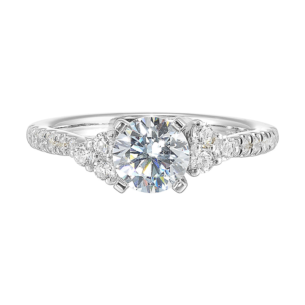Three stone ring with a cluster of diamonds along the shoulder followed by a tapered diamond shank is sure to complement her.