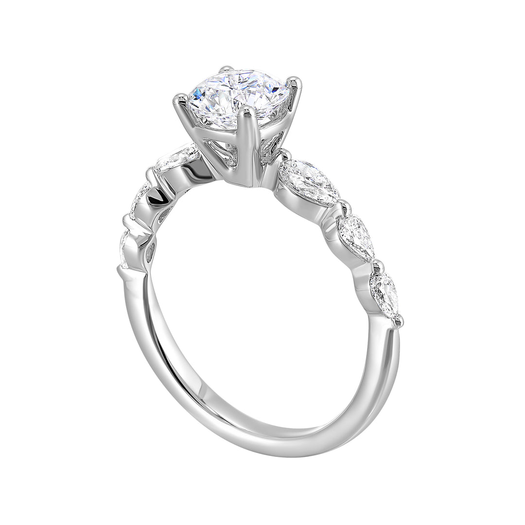 Round solitaire meets graduating pear cut diamonds set in common prongs blending classic elegance with contemporary style.