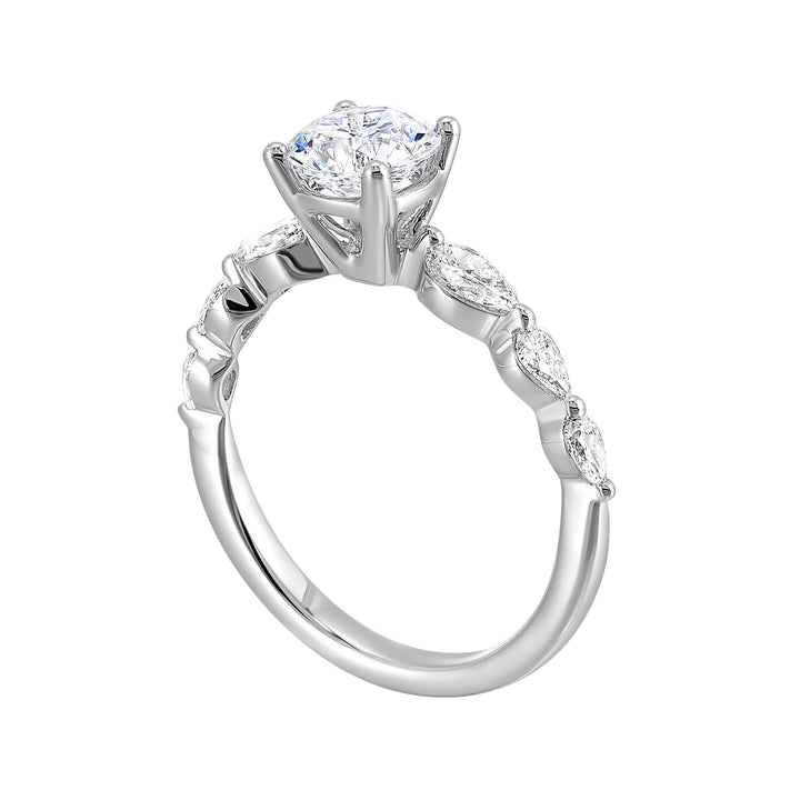 Round solitaire meets graduating pear cut diamonds set in common prongs blending classic elegance with contemporary style.