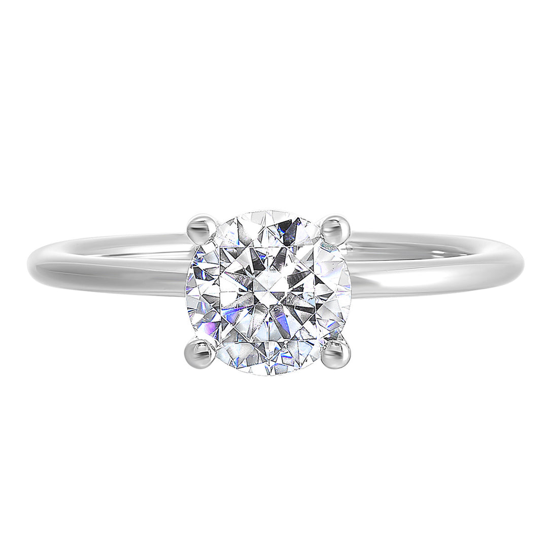 Classic four prong solitaire engagement ring with a petite band adds to the sleek, classic look of the design.
