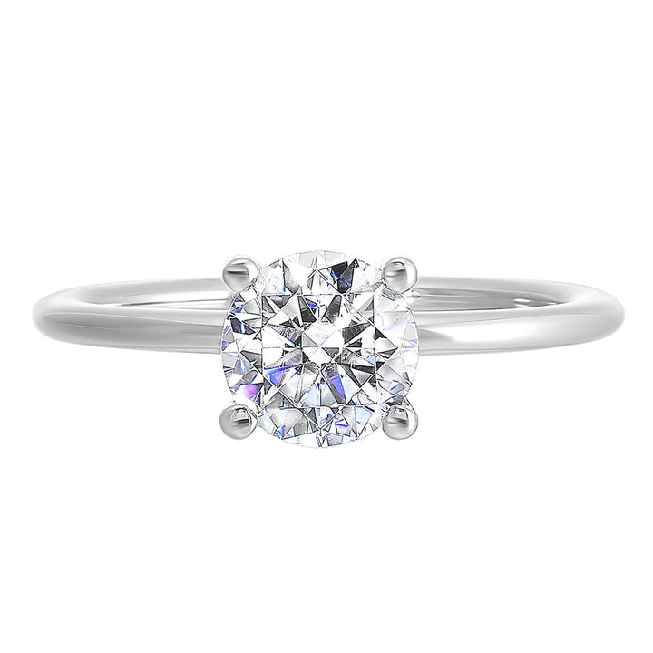 Classic four prong solitaire engagement ring with a petite band adds to the sleek, classic look of the design.