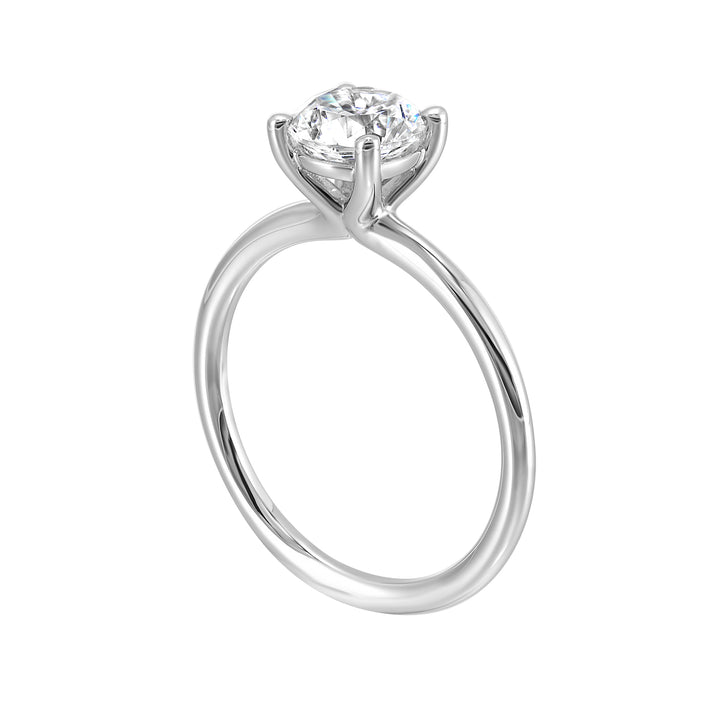 Classic four prong solitaire engagement ring with a petite band adds to the sleek, classic look of the design.