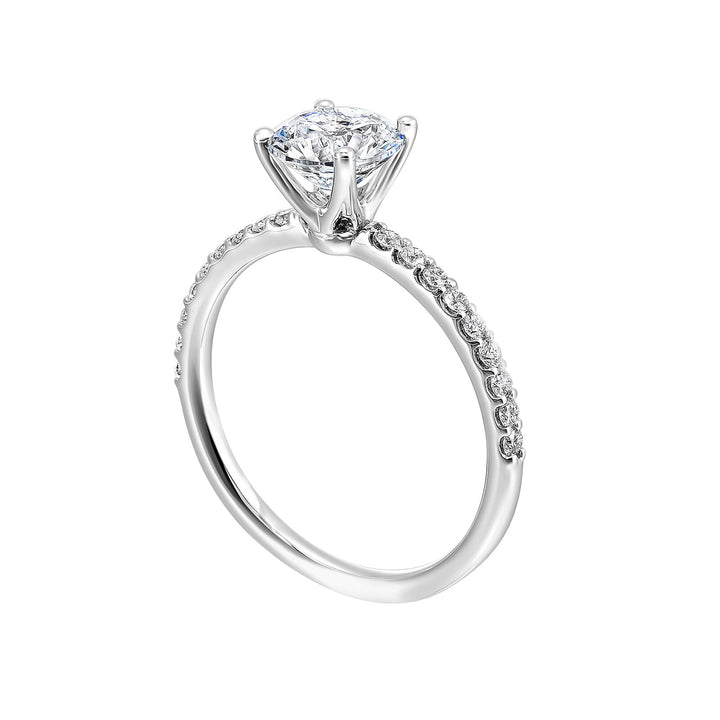 This solitaire ring boasts a dazzling micro pave on shank, offering sparkle to this delicate design offers timeless look.