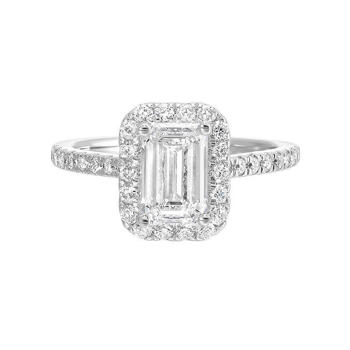 A beautiful emerald cut solitaire set with halo of round diamonds and a diamond studded shank makes this perfect choice of your love story.