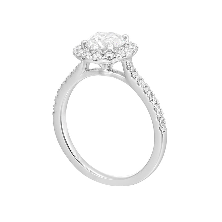 Dazzle with classic round solitaire framed by a sparkling halo. The studded shank adds a touch of classic look, making this ring a timeless symbol of elegance.