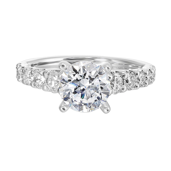 A classic round solitaire elevated by a graduating diamond shank set in common prong offers timeless elegance. Is perfect for your love story.