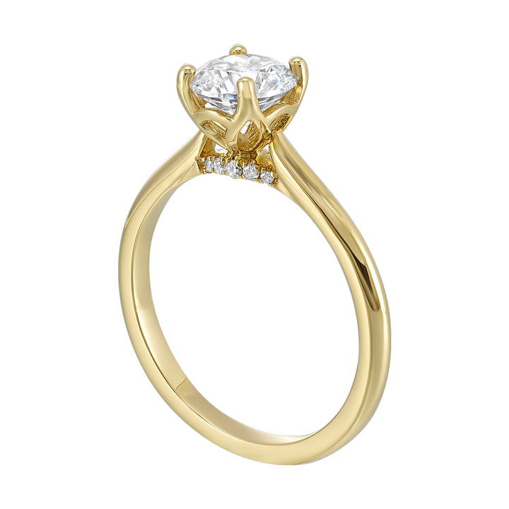 Delicate solitaire ring features a thin metal band that showcases a beaded milgrain in center with added glitters of diamonds in front.
