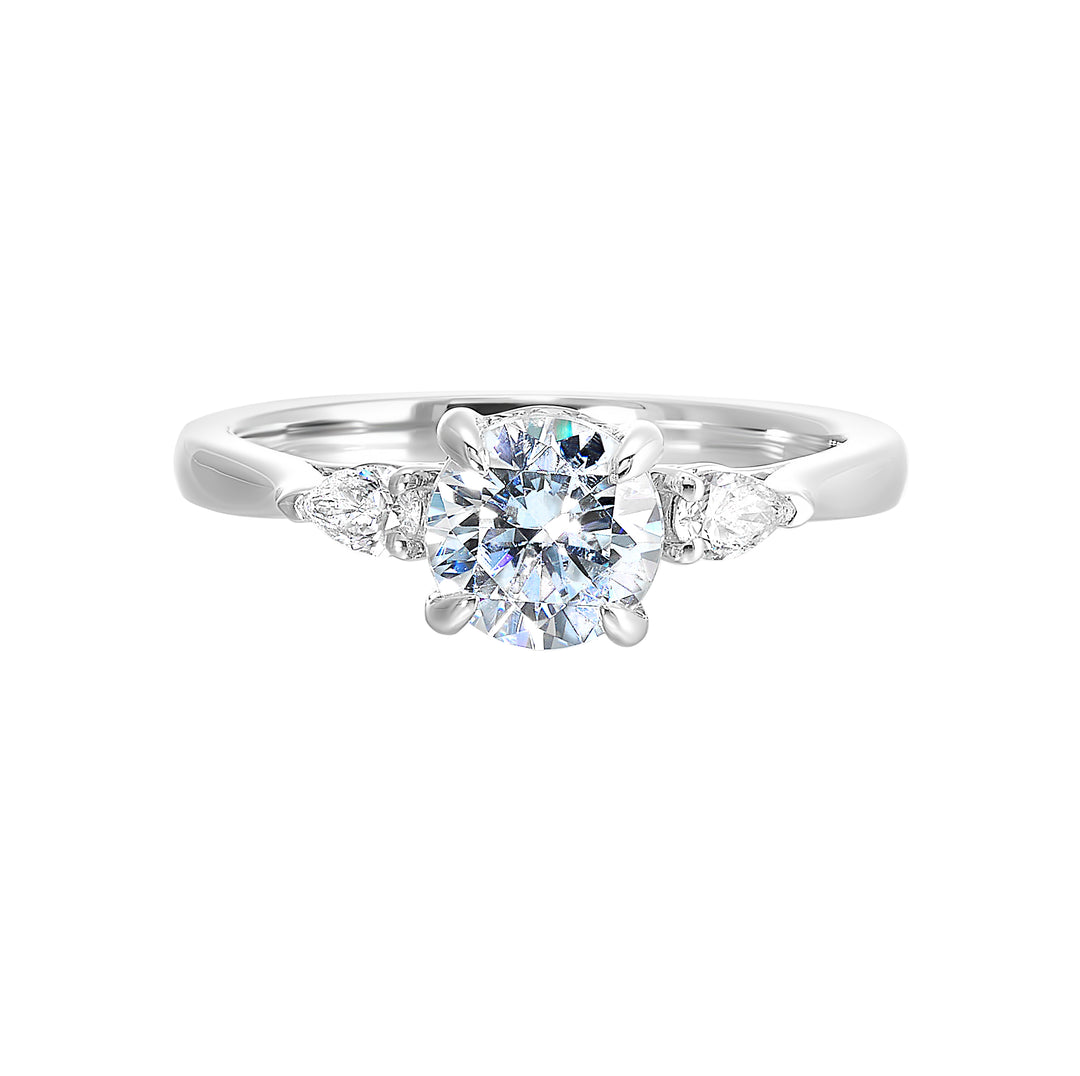 Captivating pear shaped diamonds frame the center solitare in this classic three stone ring with hidden diamond accent in front.