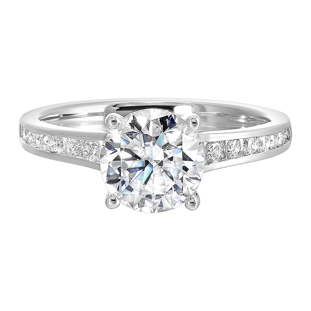 The simplicity of this single row channel set diamond shank engagement ring with four prong solitaire is simply gorgeous.