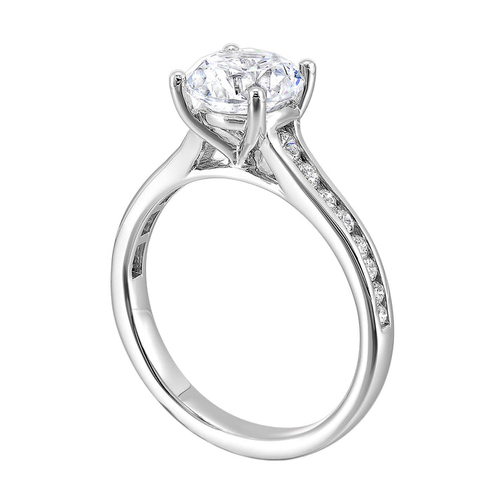 The simplicity of this single row channel set diamond shank engagement ring with four prong solitaire is simply gorgeous.