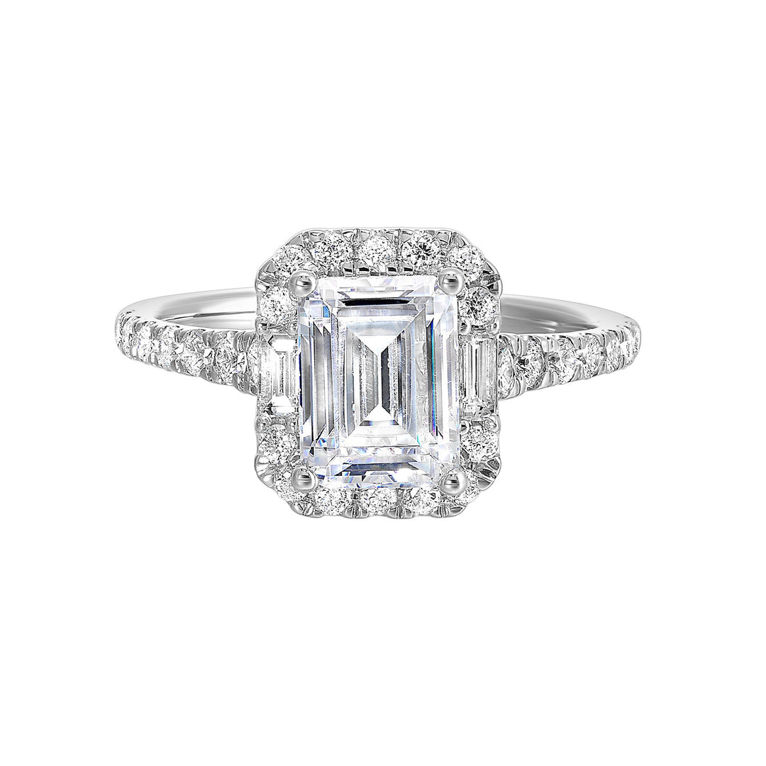 A glittering softened halo of diamonds surrounds the center emerald with adjacent baugettes on both the sides. Pave split shank adds a stylish, dazzling look.