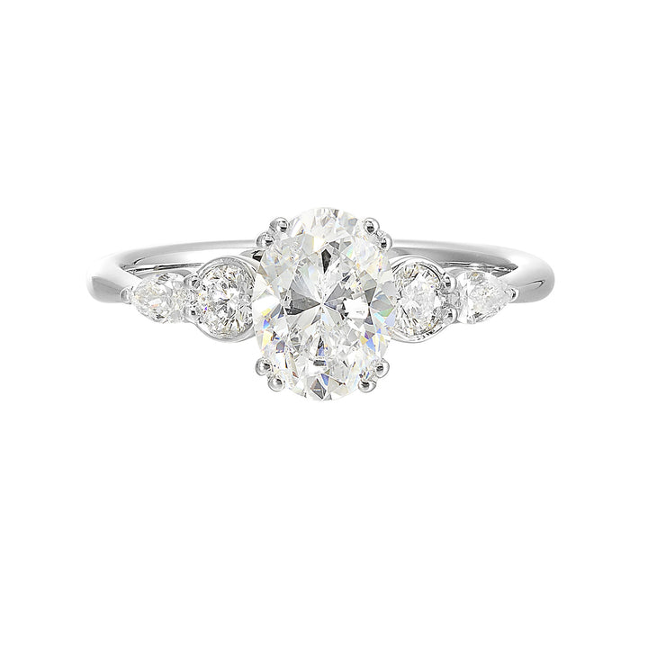 Classic five stone ring features round and pear diamonds that rest on either side of the round center diamond with a pinched shank for an elegant yet modern look.