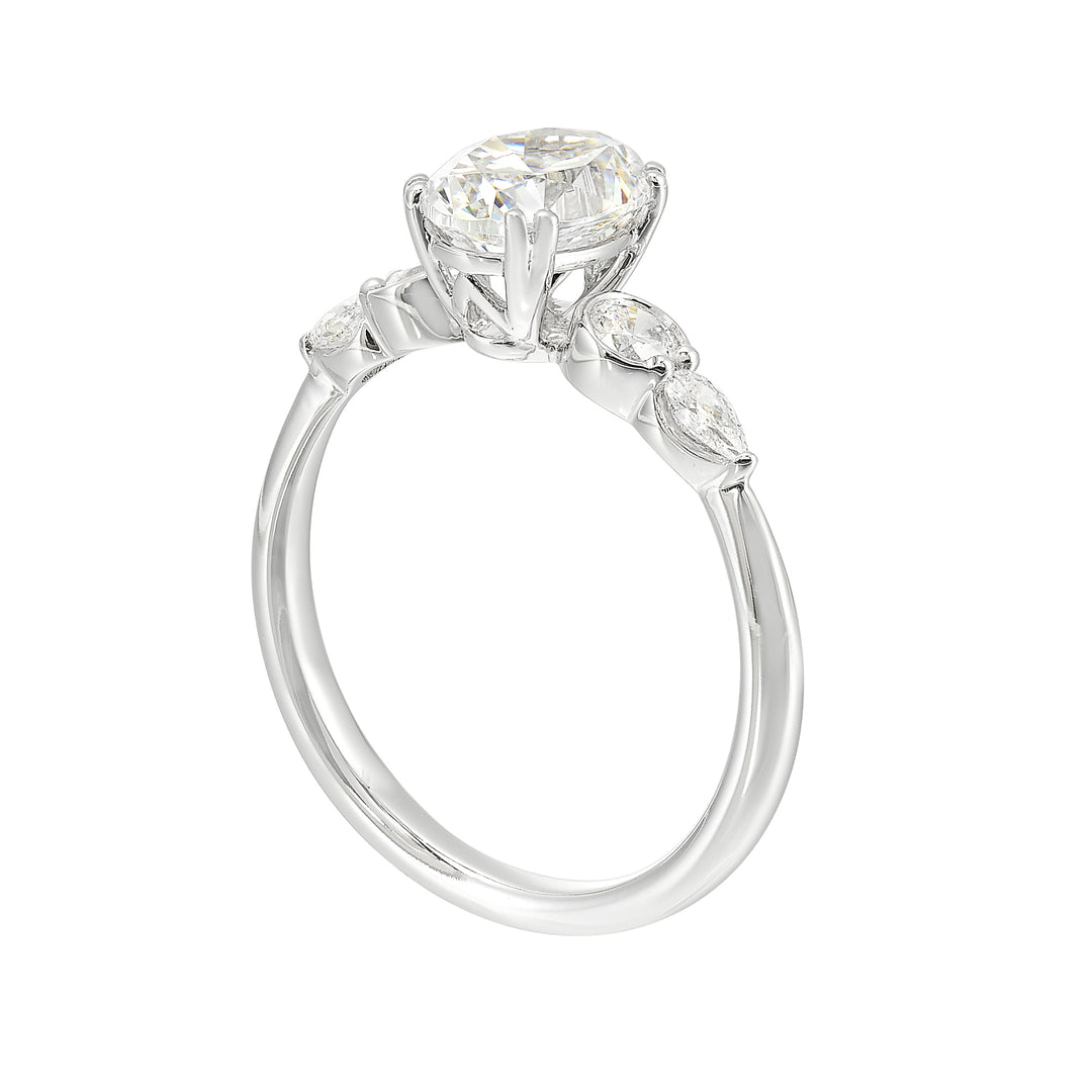 Classic five stone ring features round and pear diamonds that rest on either side of the round center diamond with a pinched shank for an elegant yet modern look.