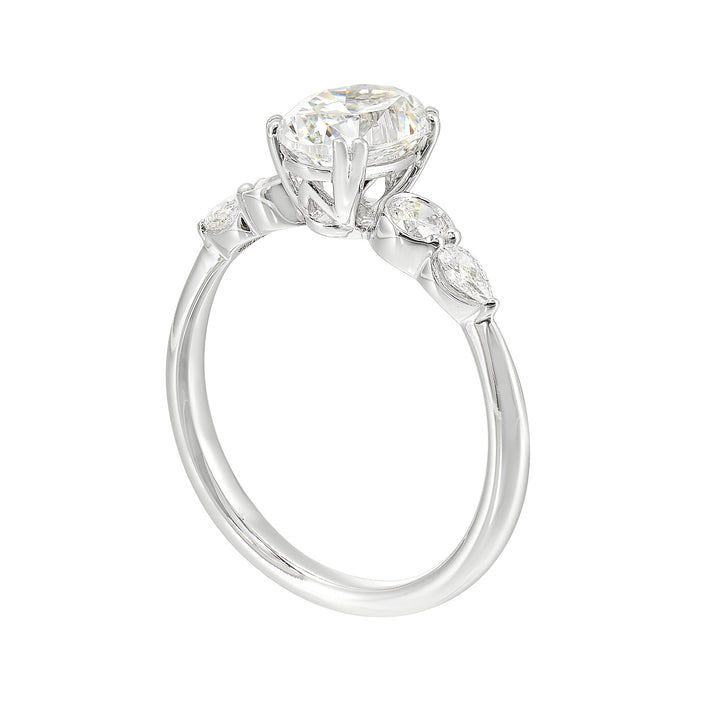 Classic five stone ring features round and pear diamonds that rest on either side of the round center diamond with a pinched shank for an elegant yet modern look.