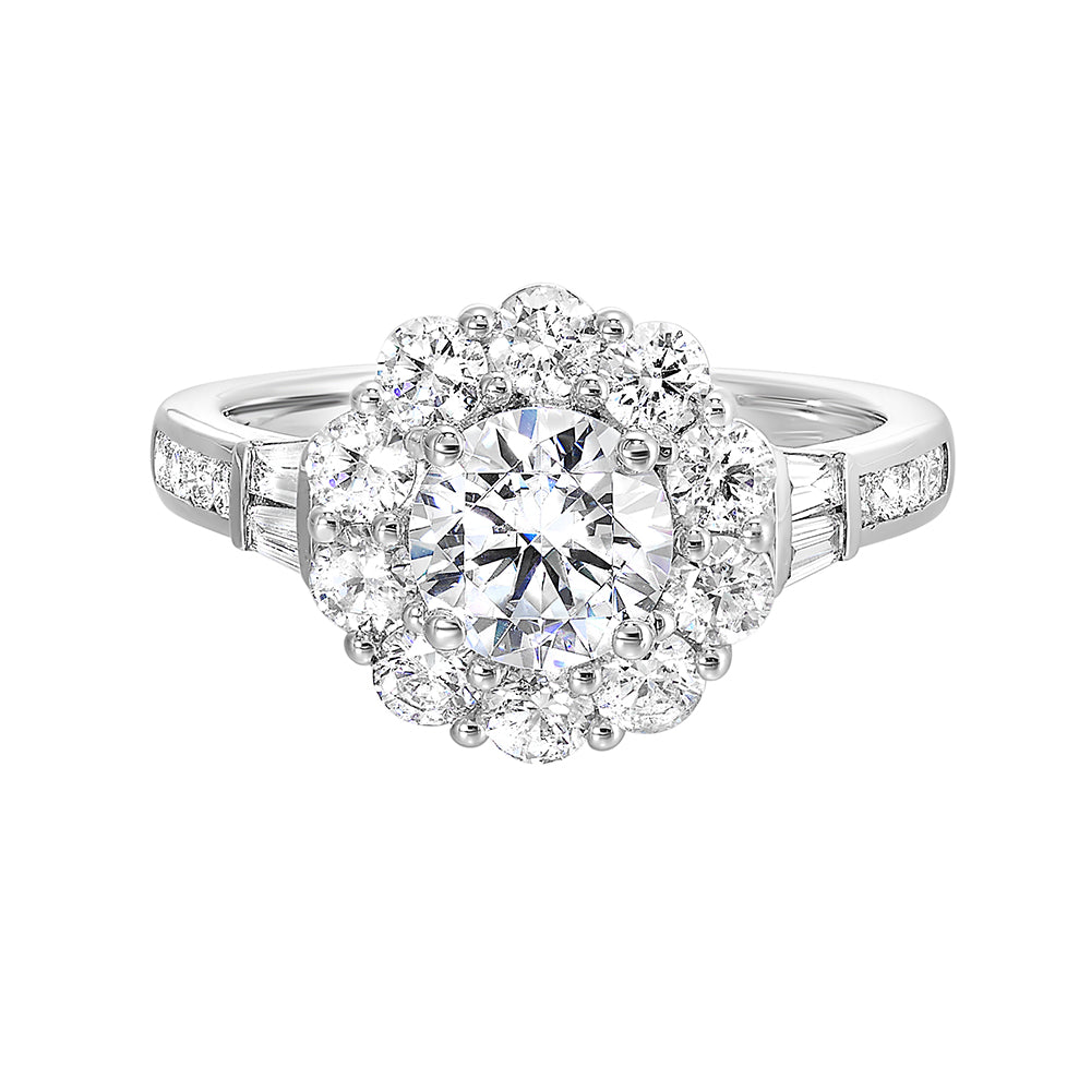 Elegant and romantic, this engagement ring highlights a floral inspired halo followed by a tapered shank of baugette and round diamonds.
