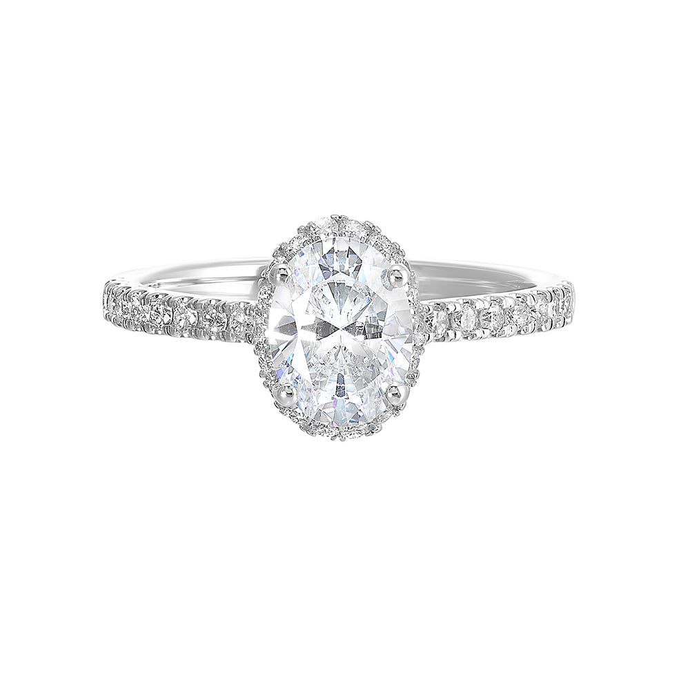 This stunning engagement ring features an oval solitare diamond, accented by pave set round diamonds on shank and a hidden halo.