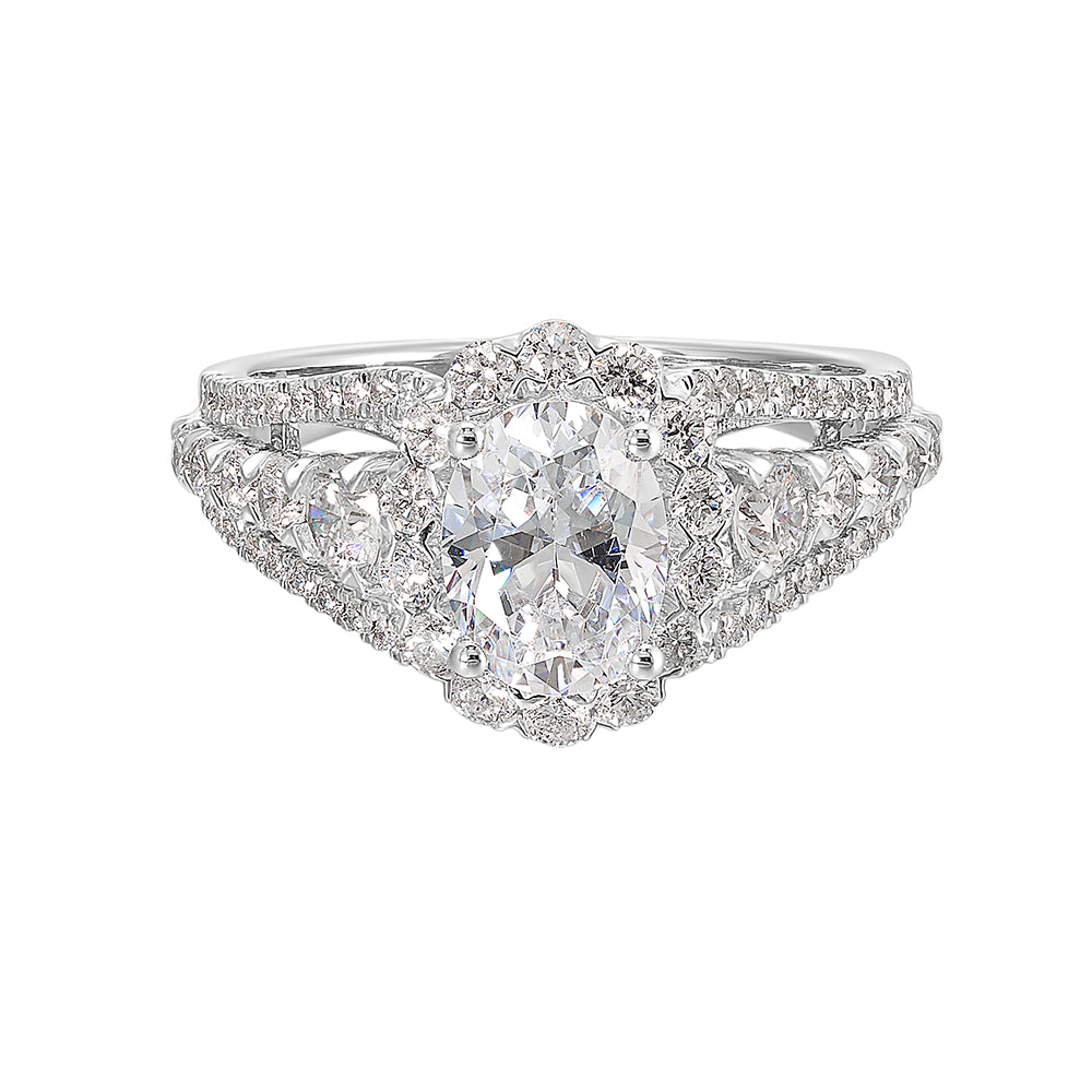 A dazzling broad ring with tapered shank consisting of bigger diamonds in the halo and center row complements her modern look.