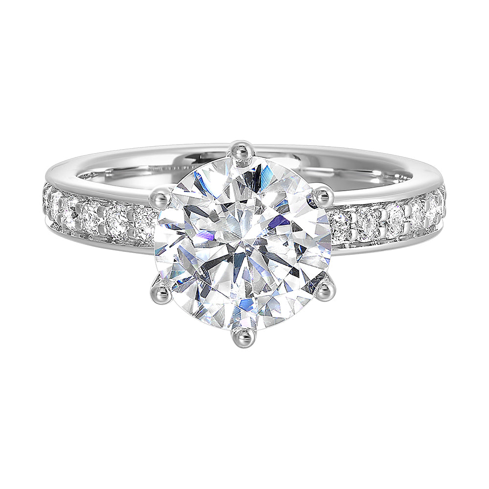 A six prong setting secures round solitare diamond with pave of diamonds in shank is perfect for the classic look.
