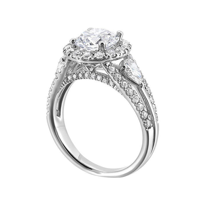 Start your love story with sparkles of this marquise and round diamond three stone engagement ring. The three rows shank have a beautiful split with pave studded diamonds on the sides.