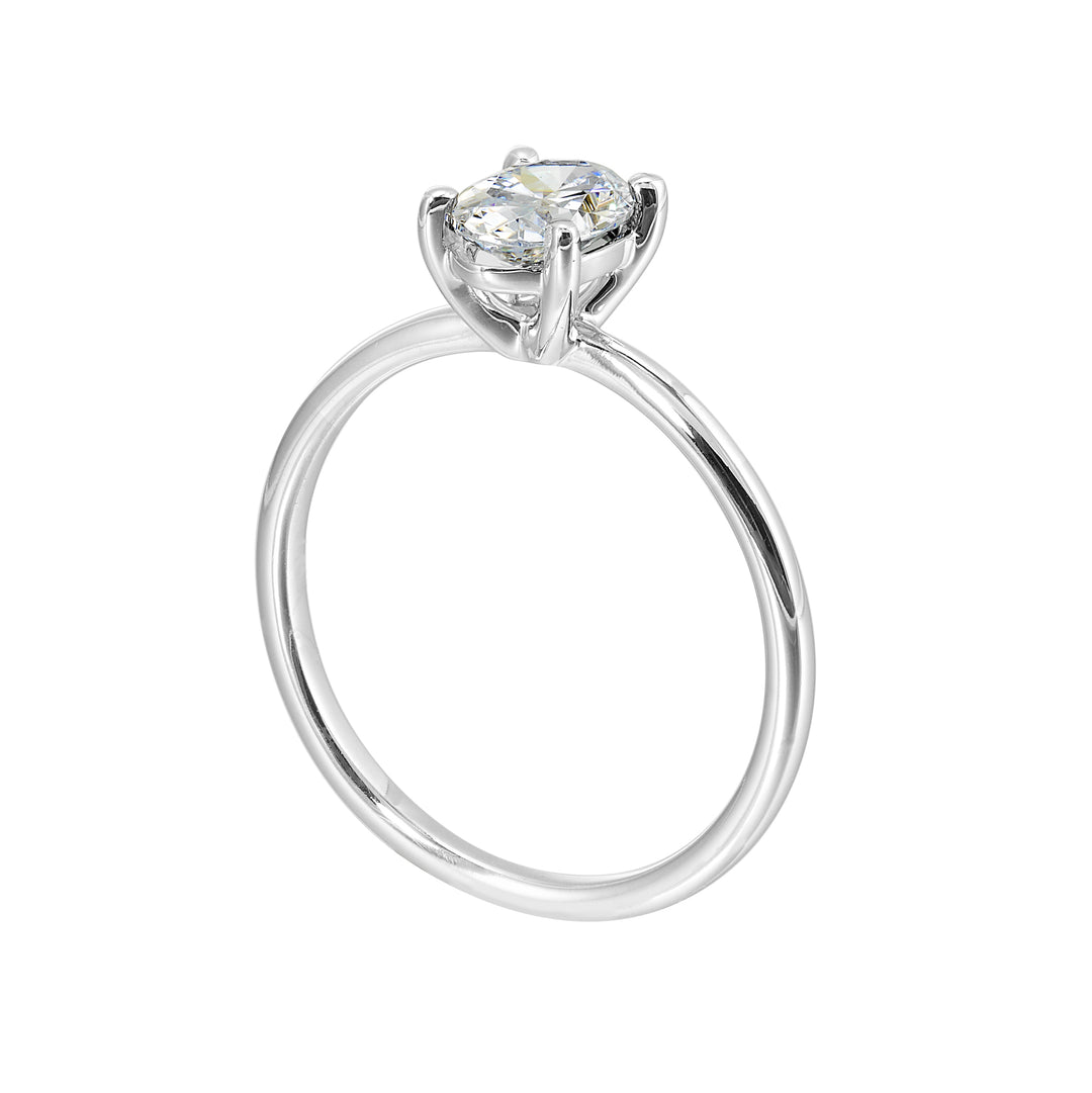 This delightful engagement ring features classic four prong oval solitaire engagement ring. The petite band adds to the sleek, classic look of this ring.