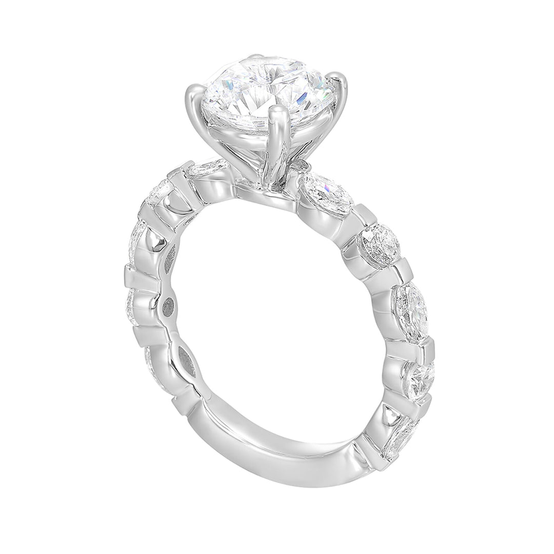 This engagement ring featues a sparkling round centre, with alternating marquise and round brilliant diamonds in the band.