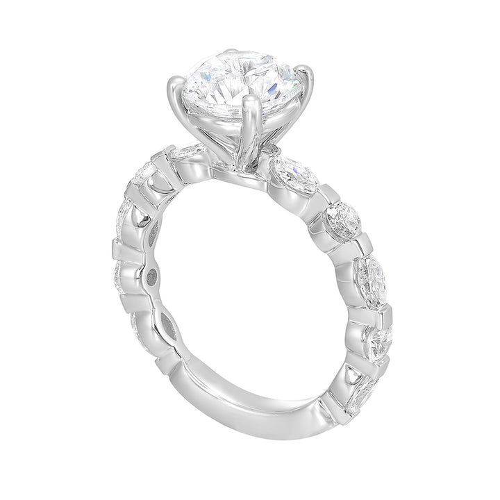 This engagement ring featues a sparkling round centre, with alternating marquise and round brilliant diamonds in the band.