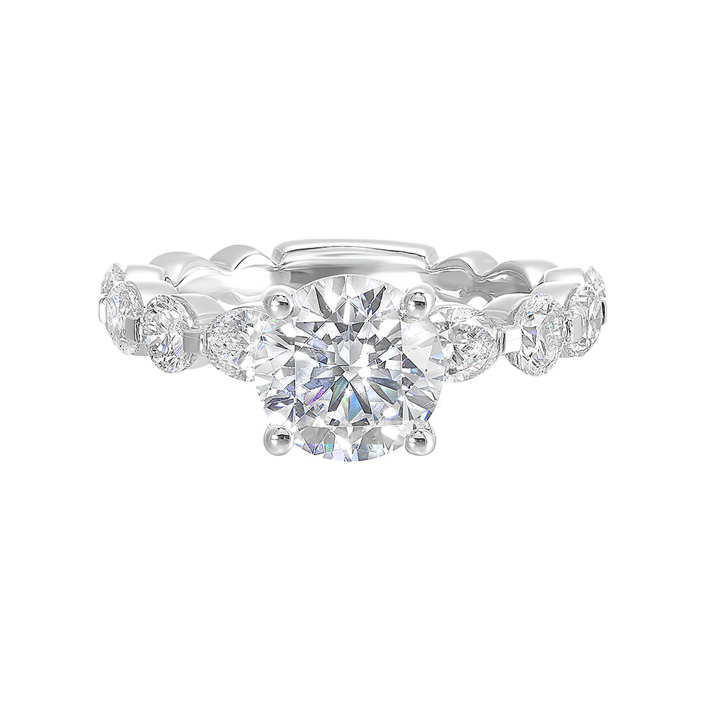 Gorgeous as you marqusie and round diamonds are set alternatively in the shank with round solitaire of this modern engagement ring.