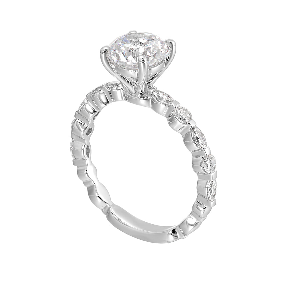 You are sure to cause a sensation with marqusie and round diamonds engagement ring highlighting the center solitaire.