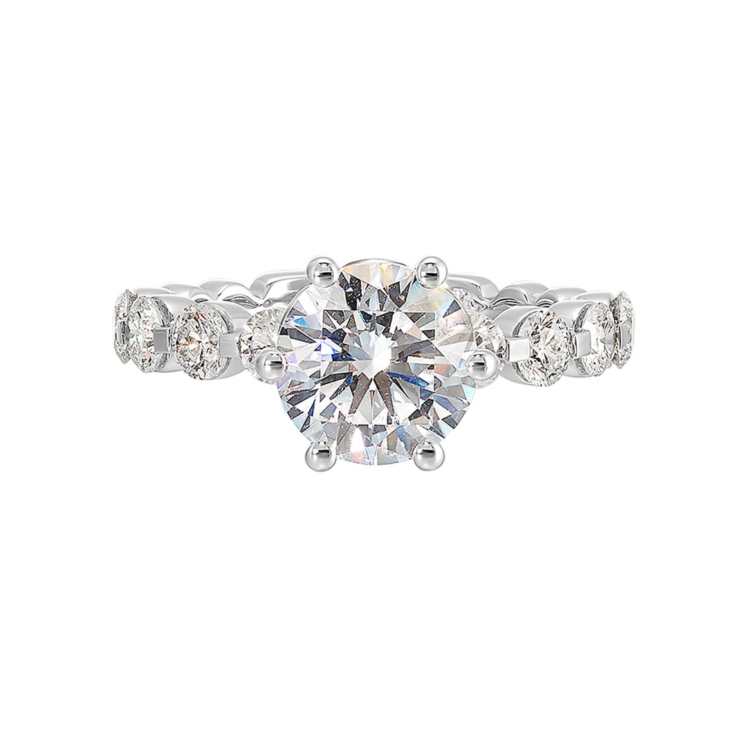 Timeless engagement ring with sparkling 6 prongs round center. Accent diamonds are set along the intricate shank with single prong look.