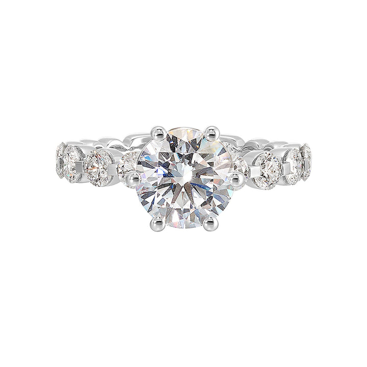 Timeless engagement ring with sparkling 6 prongs round center. Accent diamonds are set along the intricate shank with single prong look.