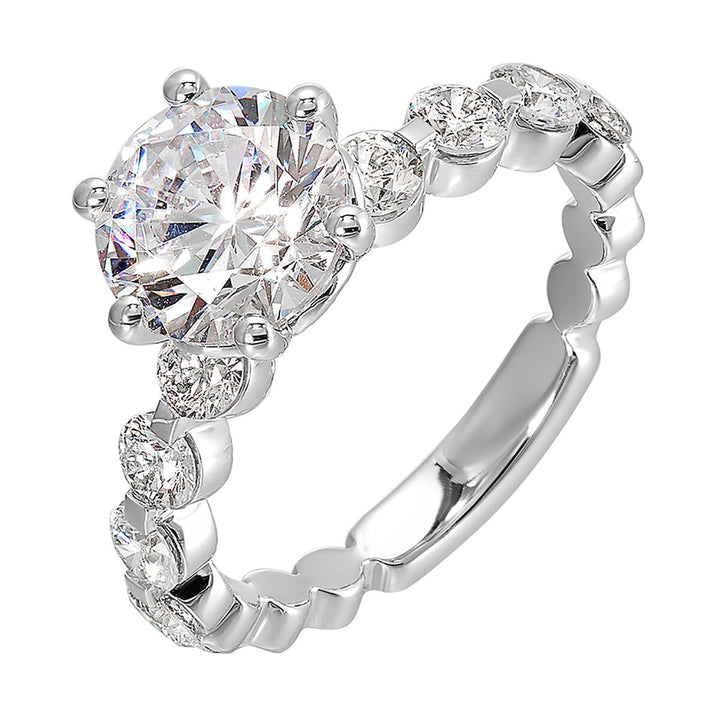 Timeless engagement ring with sparkling 6 prongs round center. Accent diamonds are set along the intricate shank with single prong look.