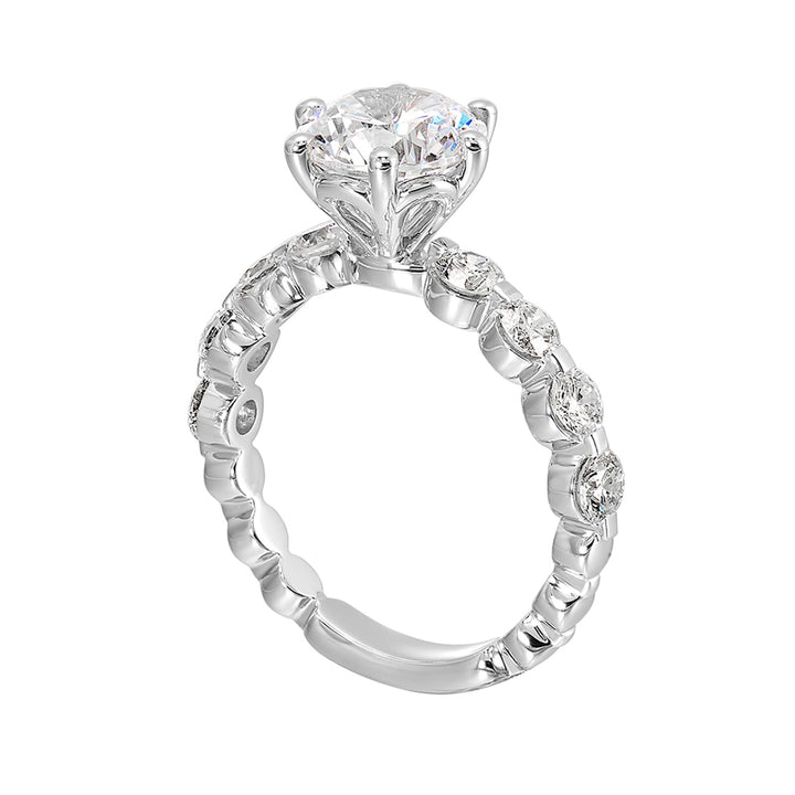 Timeless engagement ring with sparkling 6 prongs round center. Accent diamonds are set along the intricate shank with single prong look.