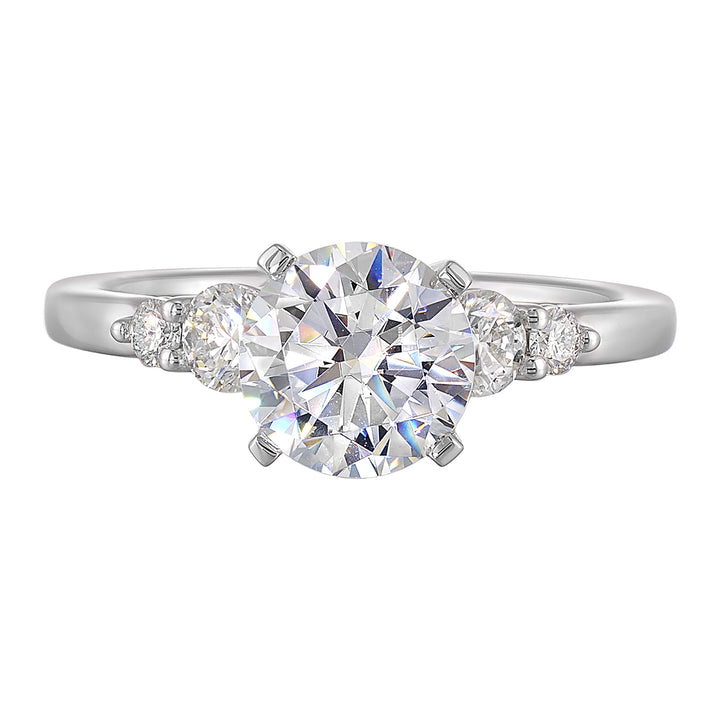 Five times diamonds for five times sparkles. A classic, lustrous band completes the look of this five stone engagement ring.