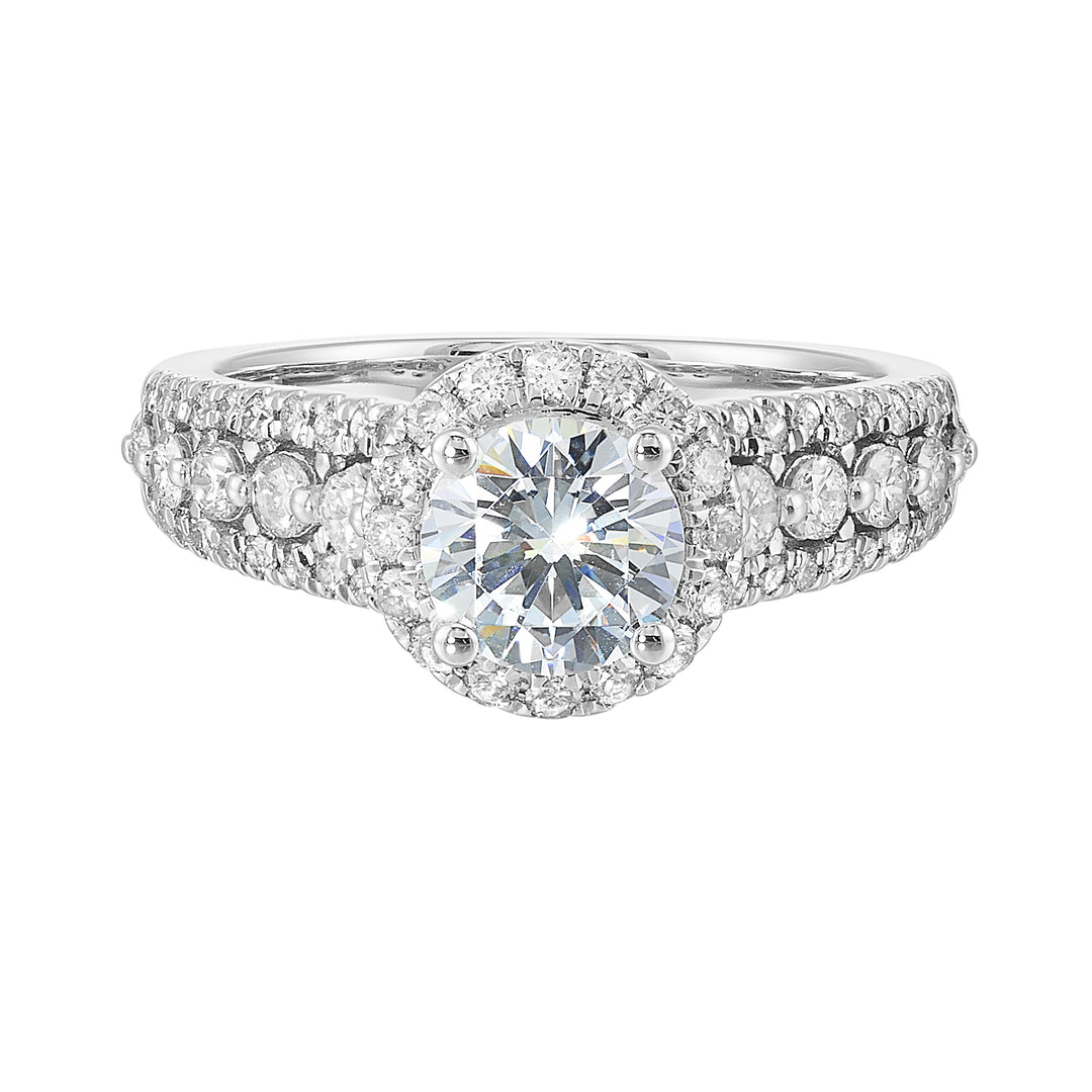 Halo shines with a stunning solitaire,  embraced by luxurious three row shank tappering towards the bottom consisting of bigger diamonds in the center row is sure of a stunner.
