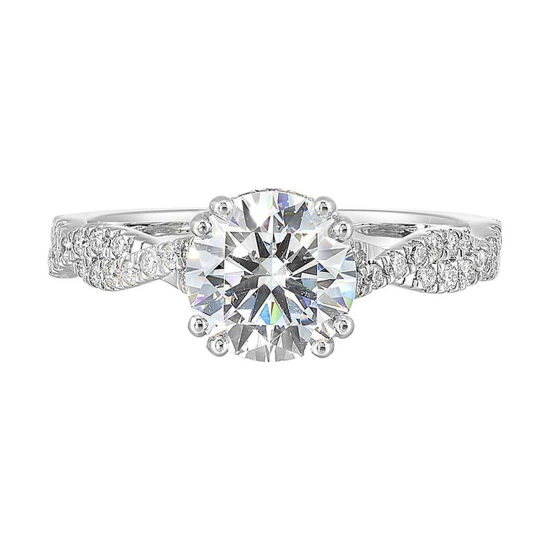 Stunning with a round solitaire diamond set in dual prongs atop a modern crisscross band. The unique twist on timeless elegance is perfect for the modern bride.