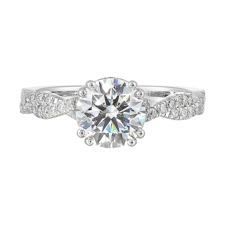 Stunning with a round solitaire diamond set in dual prongs atop a modern crisscross band. The unique twist on timeless elegance is perfect for the modern bride.