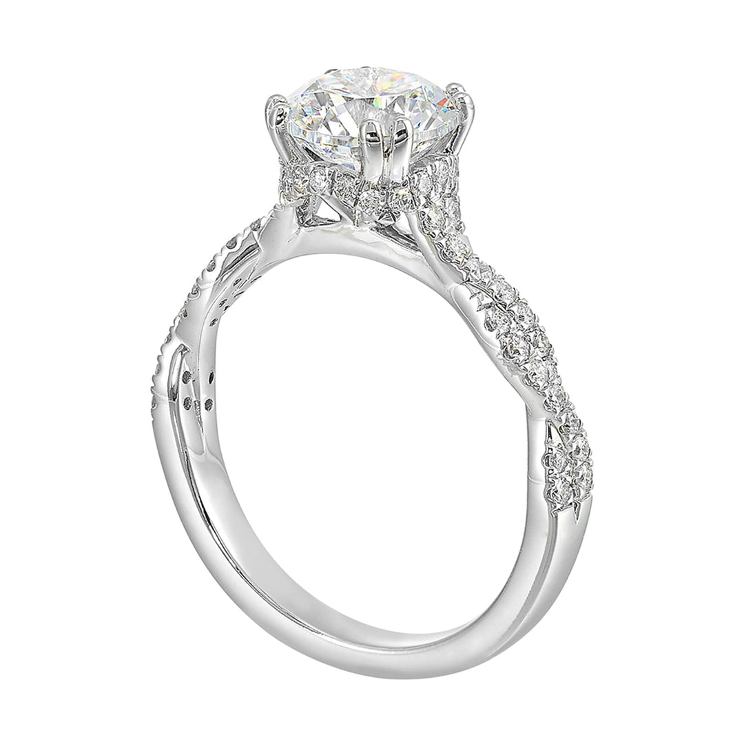 Stunning with a round solitaire diamond set in dual prongs atop a modern crisscross band. The unique twist on timeless elegance is perfect for the modern bride.