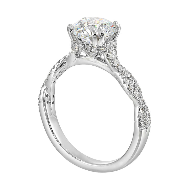 Stunning with a round solitaire diamond set in dual prongs atop a modern crisscross band. The unique twist on timeless elegance is perfect for the modern bride.